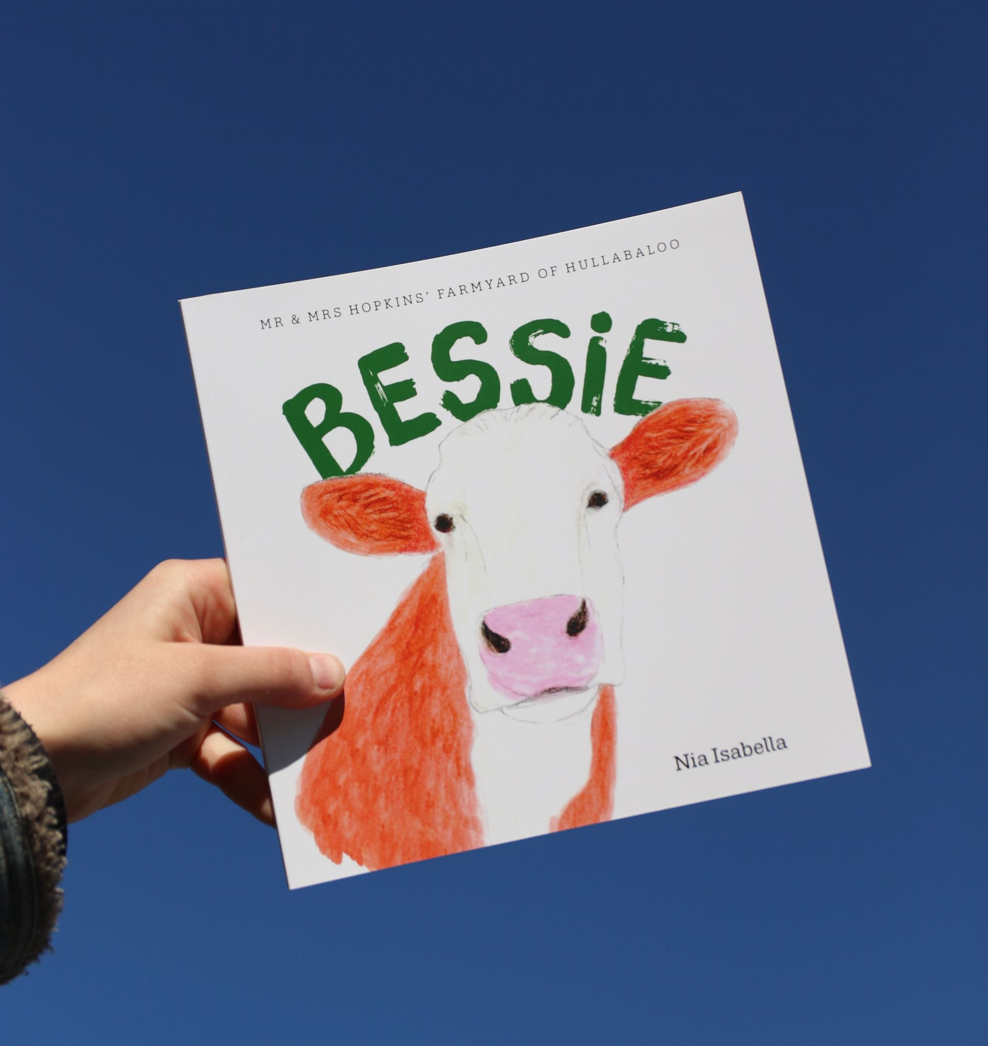 BESSIE by Nia Isabella — cover held against a blue sky
